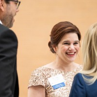 Laura Aikens speaking with guests during the Enrichment reception